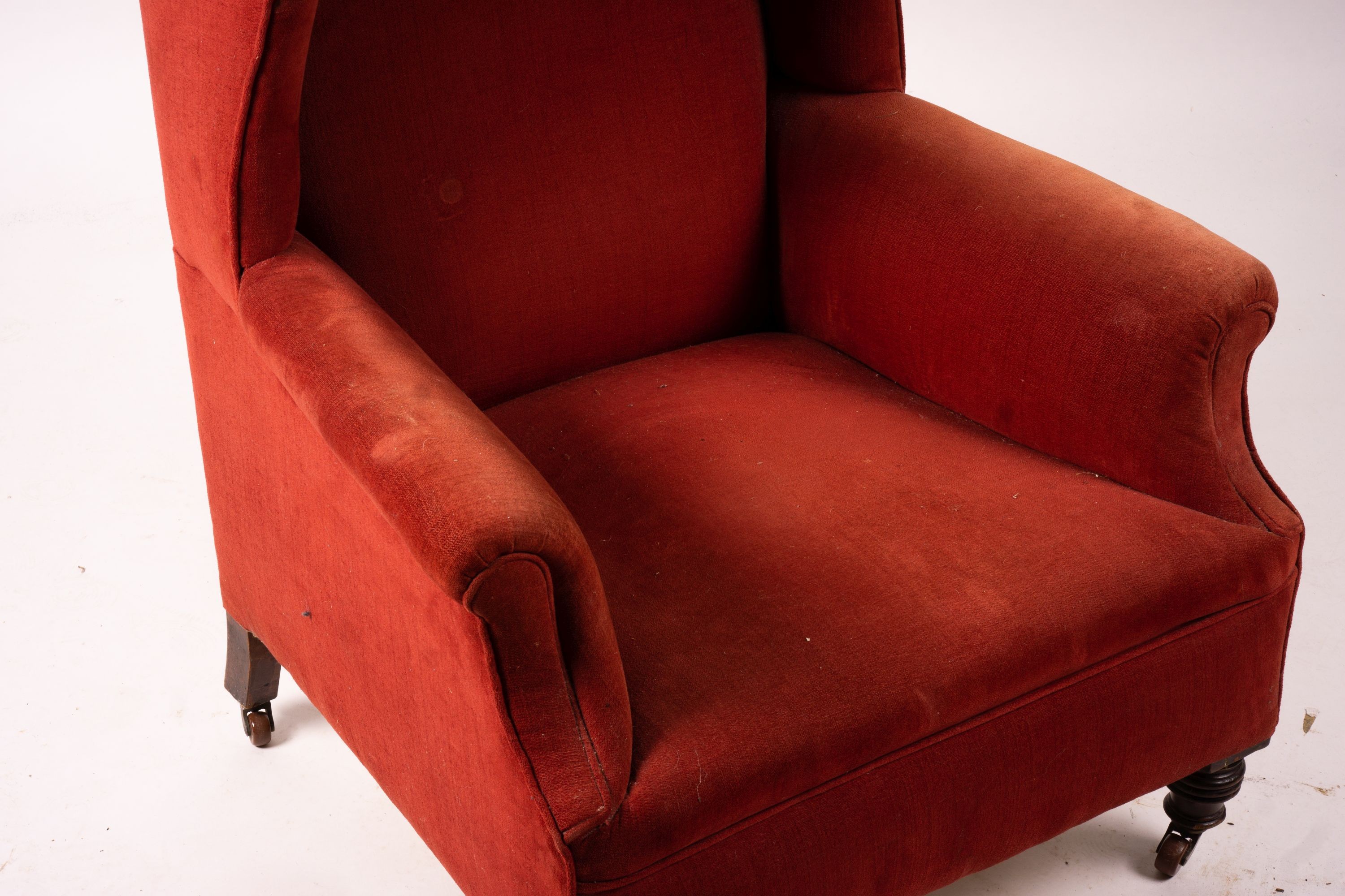 A late Victorian upholstered wing armchair, width 76cm, depth 70cm, height 100cm